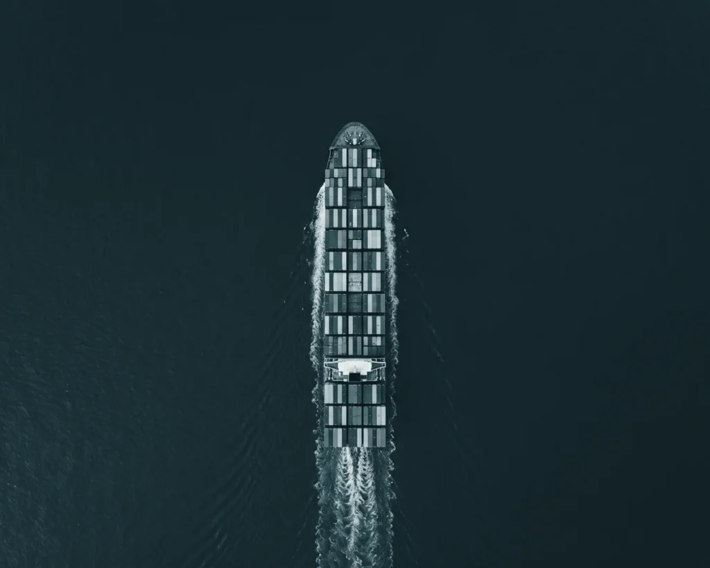 Container ship crossing open water, seen from directly above